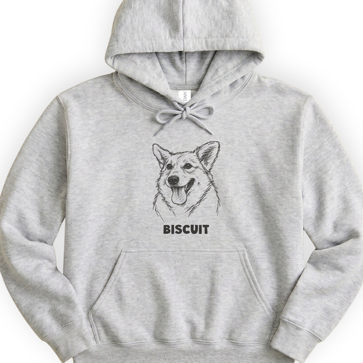 The Portrait Hoodie in Ash with a portrait of a corgi and the name Biscuit