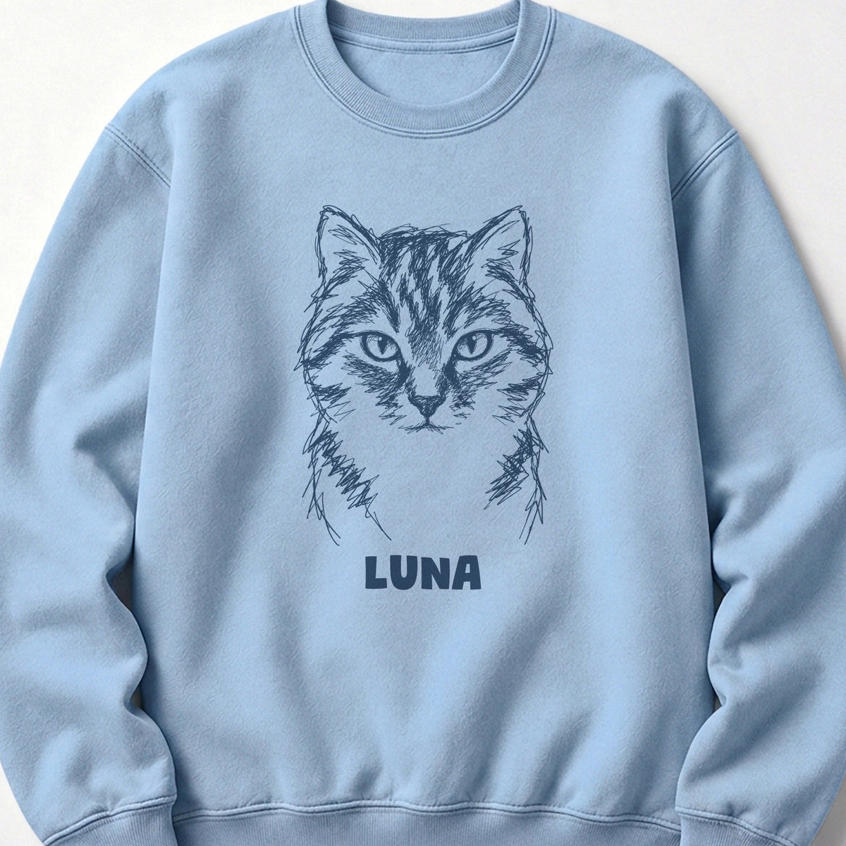 The Portrait Crewneck in Light Blue with a portrait of a tabby cat and the name Luna