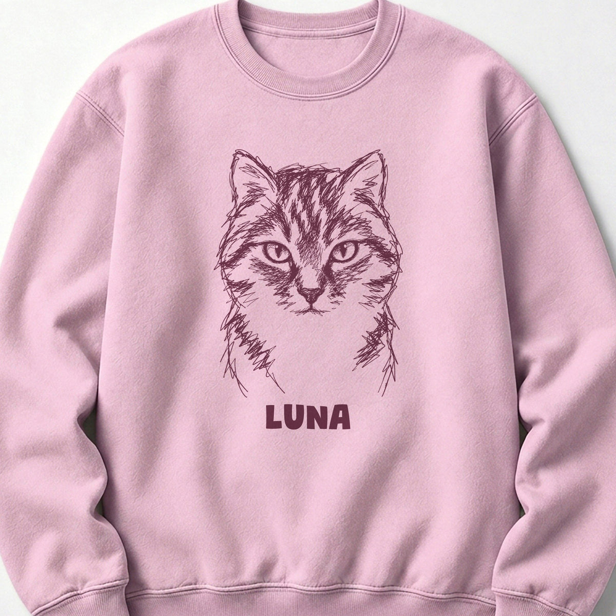 The Portrait Crewneck in Light Pink with a portrait of a tabby cat and the name Luna