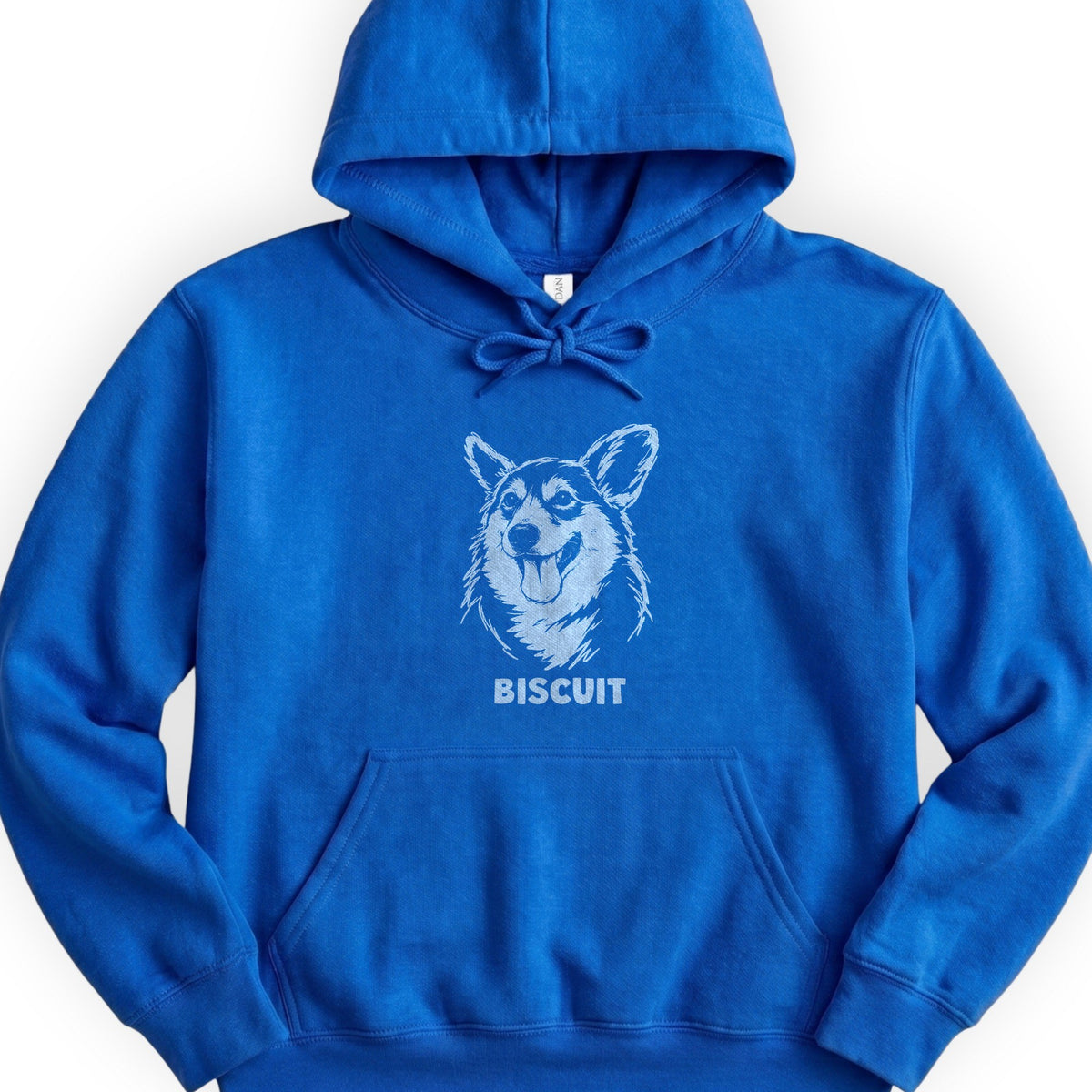 The Portrait Hoodie in Royal with a portrait of a corgi and the name Biscuit