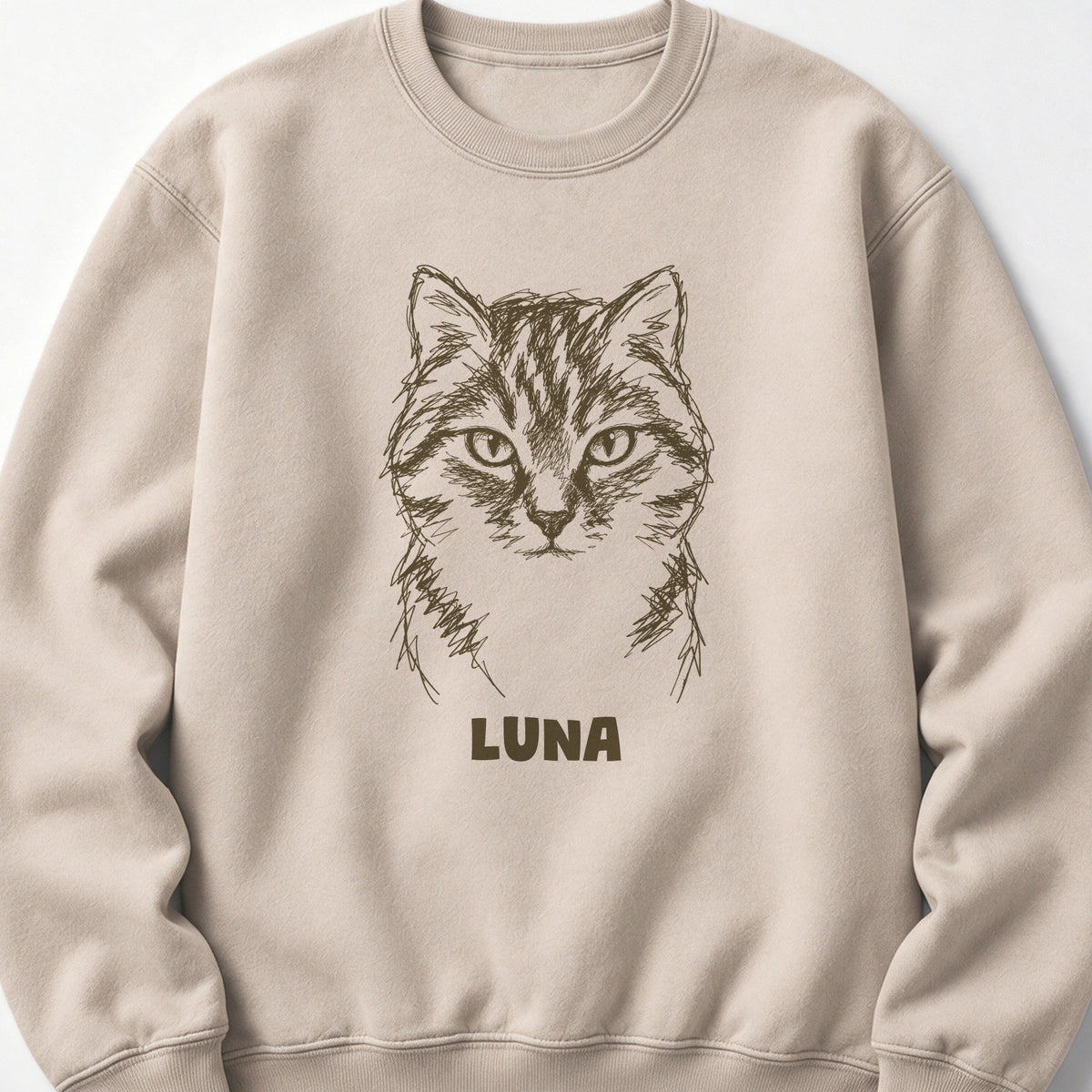 The Portrait Crewneck in Sand with a portrait of a tabby cat and the name Luna